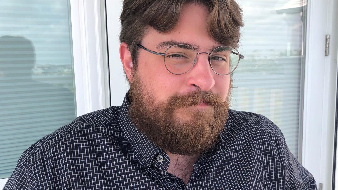 Man sitting in front of window.