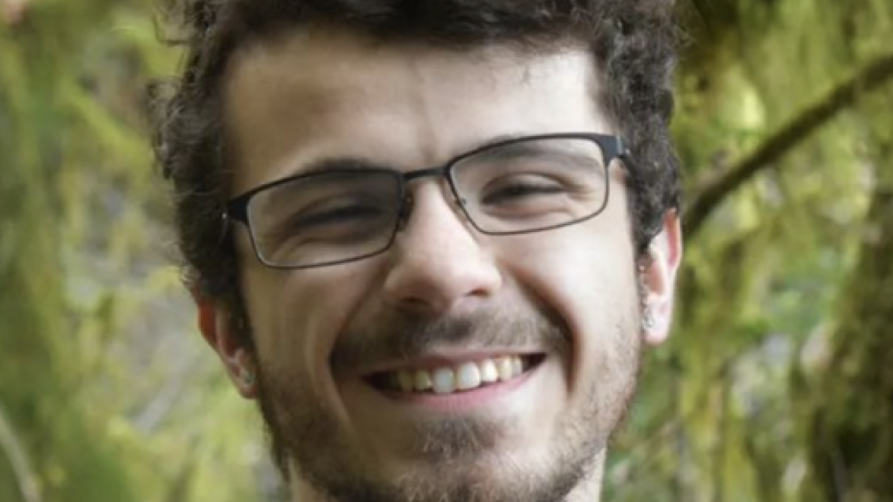 man smiling into camera.