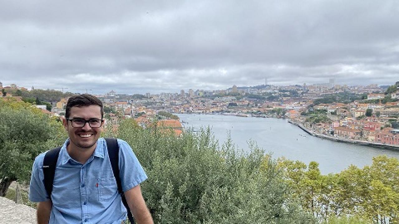 Man with blue shirt in front of river
