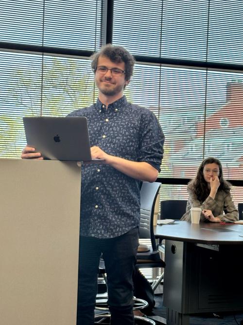man standing at podium presenting.