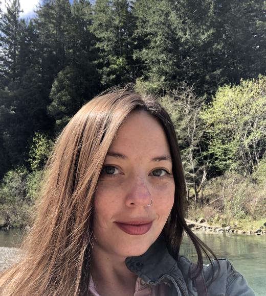 A photo of a woman (Haley Williams) with trees in the background.