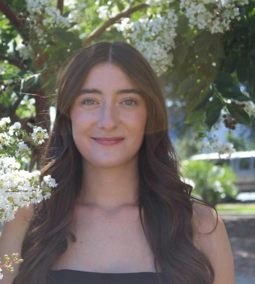 woman in front of white blooming tree