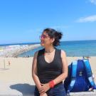 woman sitting on sand of ocean shore